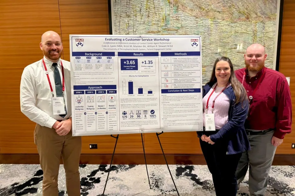 Cole Lyons with training and operations partners beside the Penn AQM customer-service workshop poster at the Patient Access Collaborative symposium.